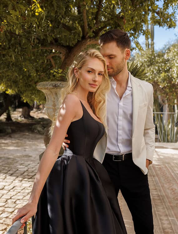 Honeymoonshop trouwjurk en trouwpak, romantisch paar buiten.