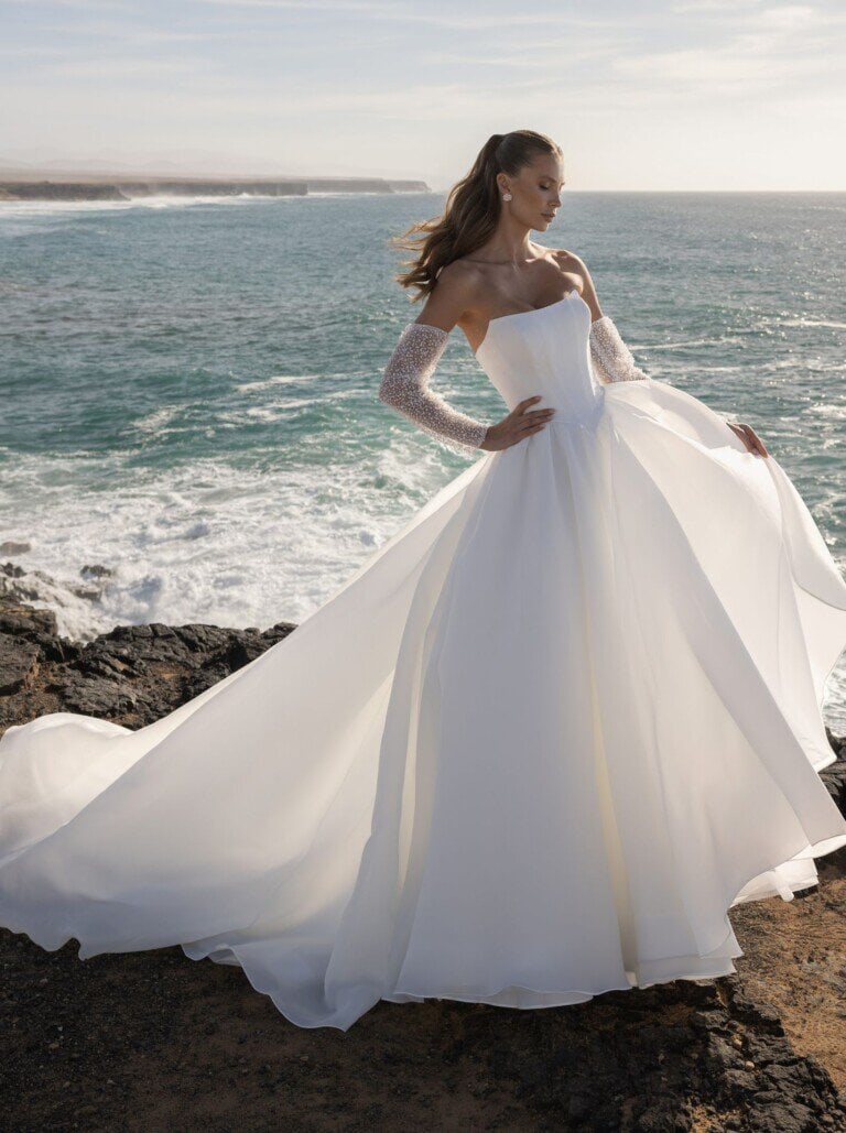 Huwelijksjurk met lange mouwen en sleep, Honeymoonshop, trouwjurken, trouwpakken.